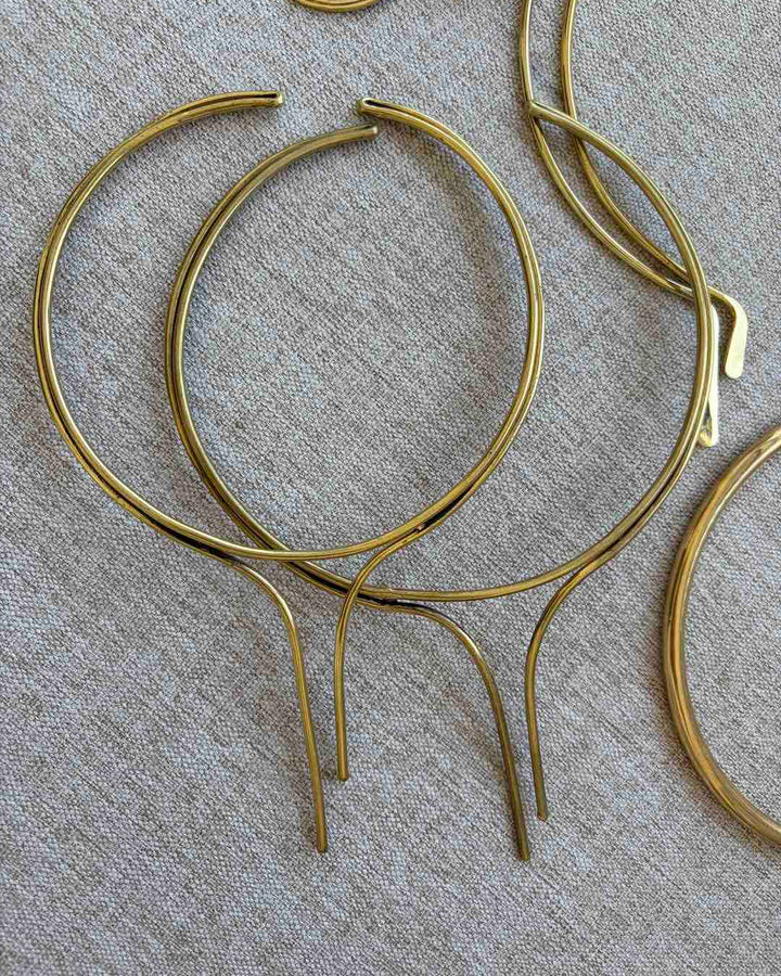 Set of brass chokers on a textured surface