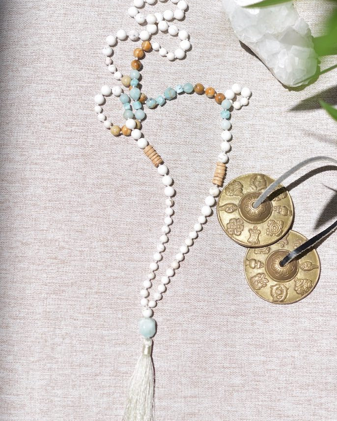 Necklace with beads and tassel on a textured surface