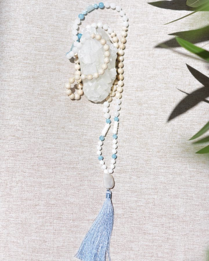 Necklace with beads and a tassel on a textured surface