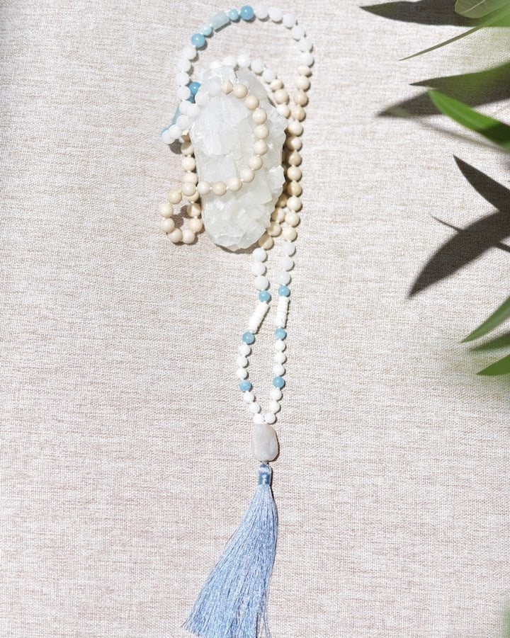Necklace with beads and a tassel on a textured surface