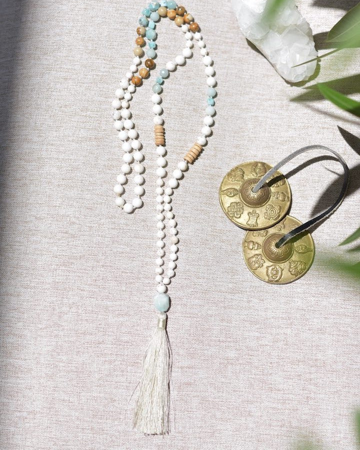 Necklace with beads and tassel on a textured surface