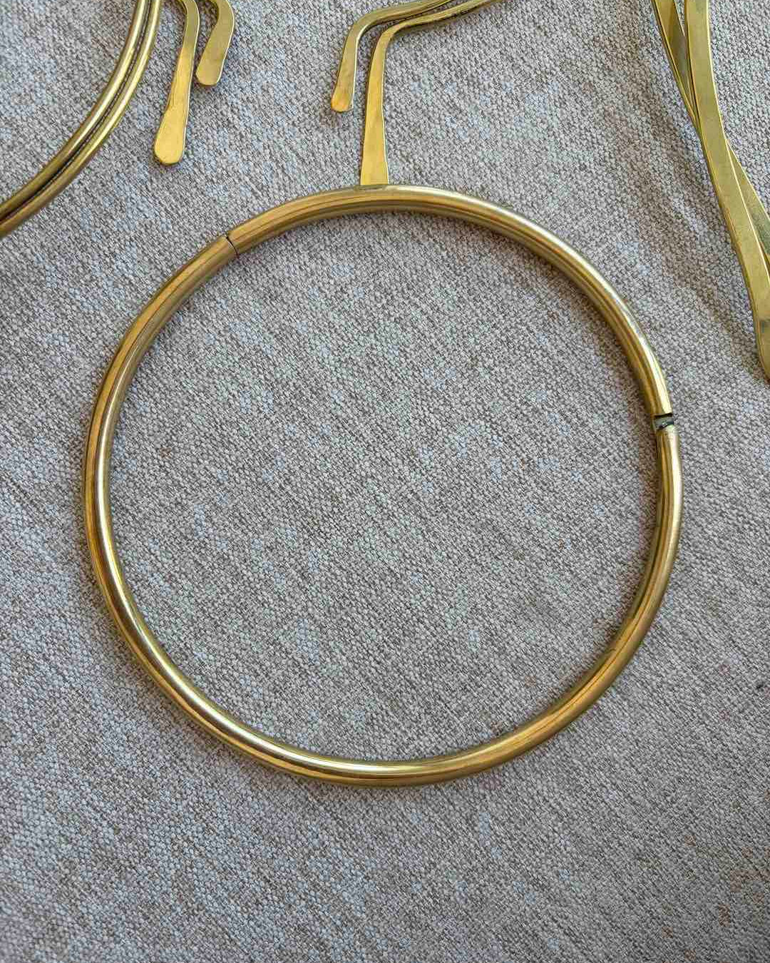 Brass neck choker on a textured surface