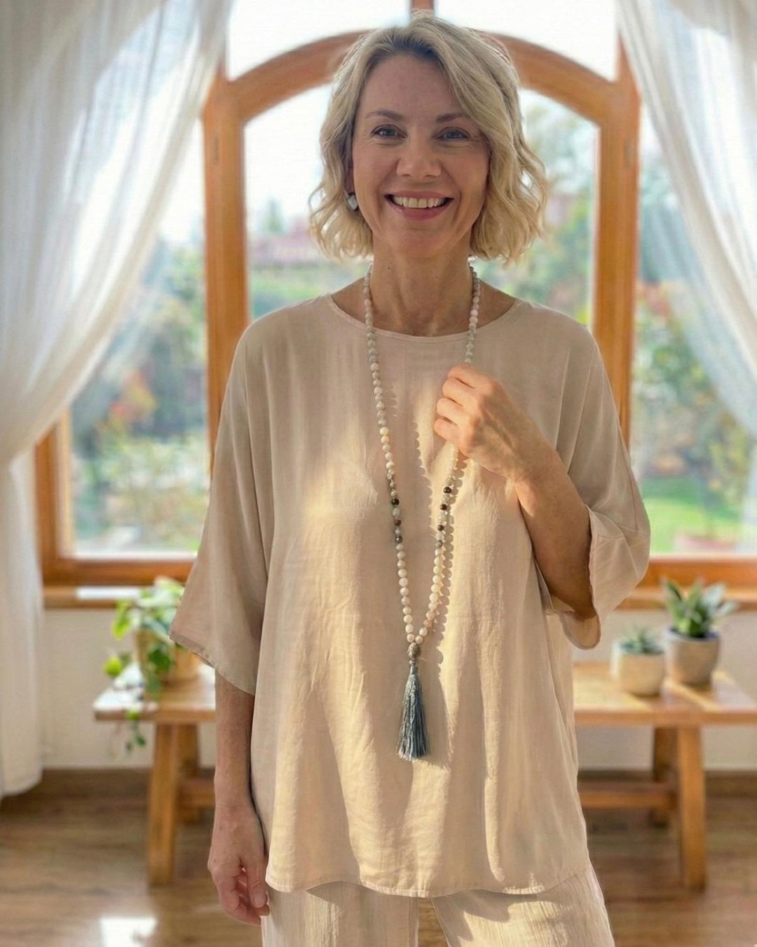 Beautiful lady wearing gemstone mala necklace