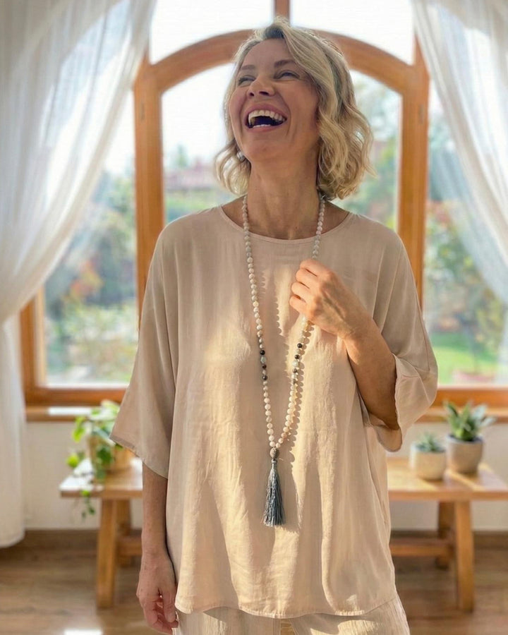 Smiling lady wearing gemstone Mala