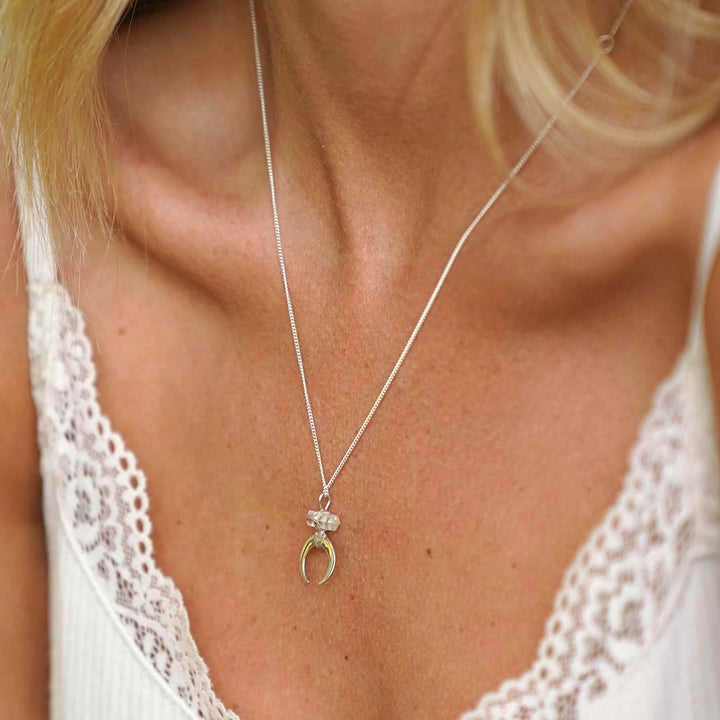 Lady wearing True Balance Moon Crescent Necklace with Clear Quartz & Sterling Silver