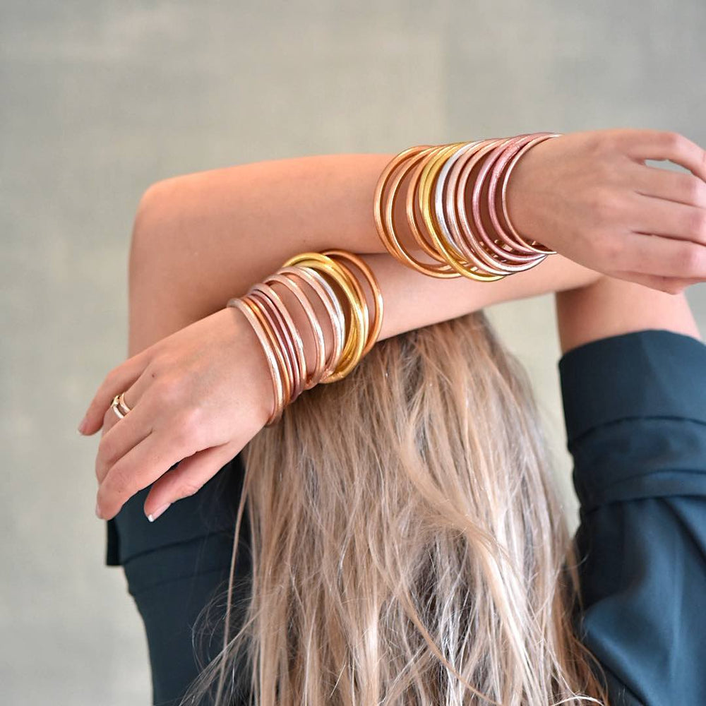 lady wearing a stack of Gold Leaf Temple Bangle with Mantra 