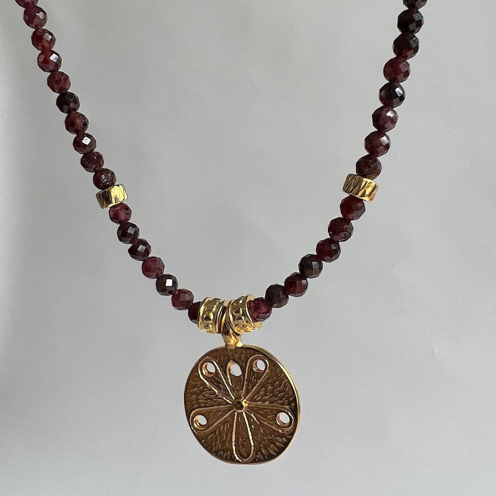 Natural Passion gemstone necklace with Garnet and a flower pendant by Manipura