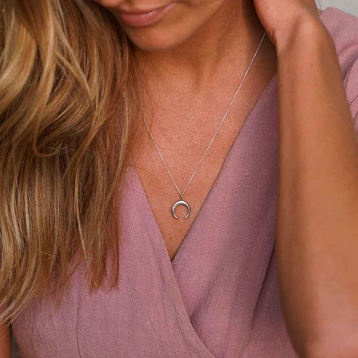 Lady wearing Inner Glow Necklace with a Handmade Moon Crescent in Sterling Silver