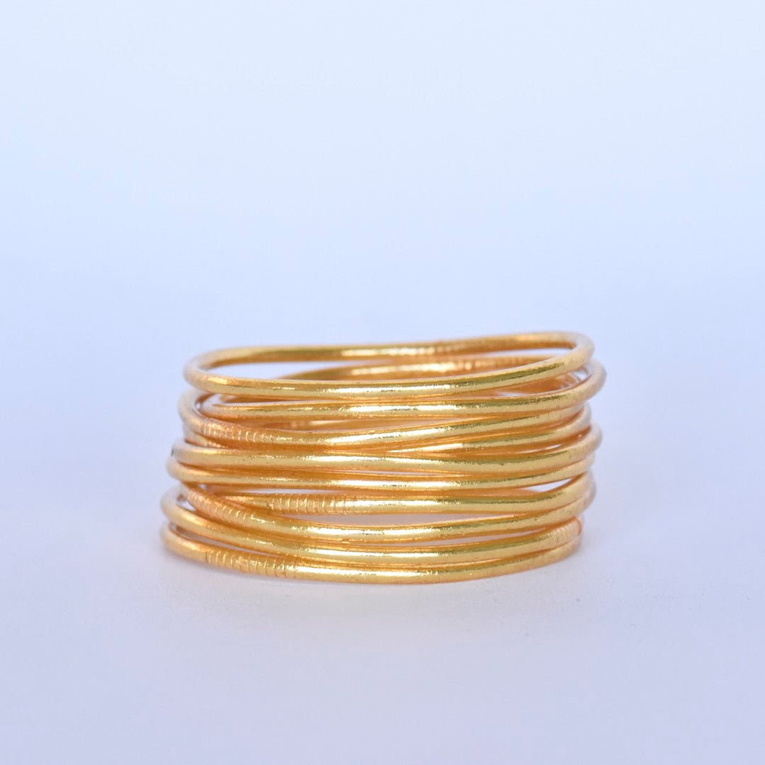 Ten thin Buddha Gold Leaf Temple Bangles with Mantra by Manipura Amsterdam